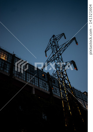 abandoned high voltage power supply line pylon with damaged wires 141321604