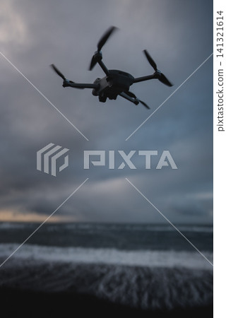 small professional photography and video drone fly over sea 141321614