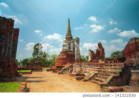 Ancient headless Buddha statues lining the red brick wall at Wat Mahathat in Ayutthaya, Thailand. 141322830