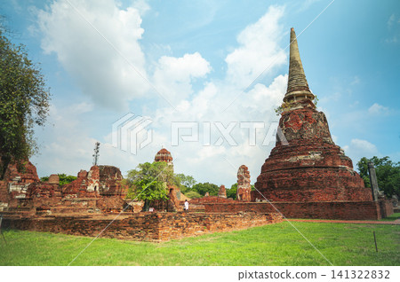 Ancient headless Buddha statues lining the red brick wall at Wat Mahathat in Ayutthaya, Thailand. Ancient headless Buddha statues lining the red brick wall at Wat Mahathat in Ayutthaya, Thailand. 141322832