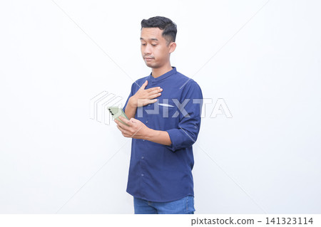 Man holds phone, hand covers mouth in shock. His eyes widen, eyebrows raised. White background isolates the emotion clearly. Ideal for stories of surprise or unexpected news. Man holds phone, hand covers mouth in shock. His eyes widen, eyebrows raised. White background isolates the emotion clearly. Ideal for stories of surprise or unexpected news. 141323114