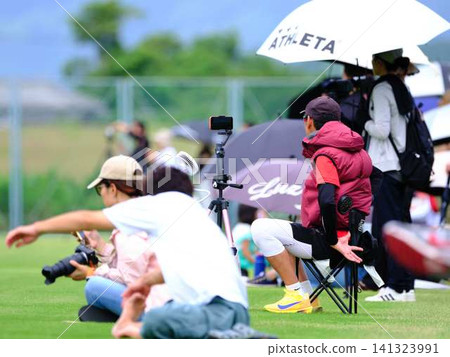 Parents watching over their children at the school sports day 141323991
