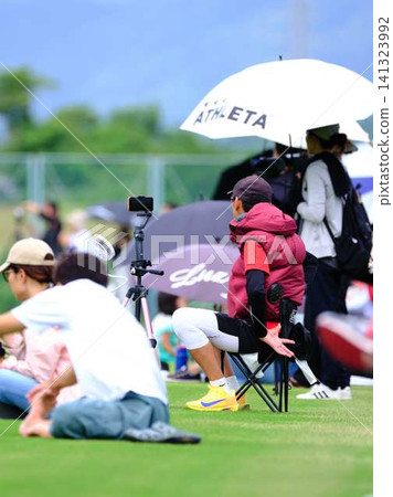 Parents watching over their children at the school sports day Parents watching over their children at the school sports day 141323992