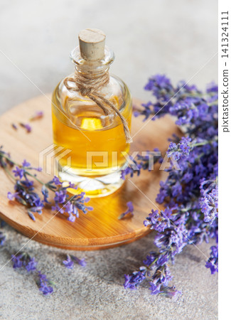 Lavender essential oil bottle with fresh flowers Lavender essential oil bottle with fresh flowers 141324111