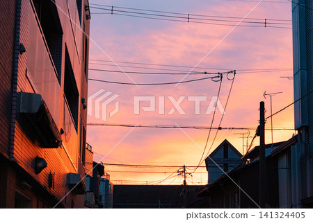 A city sunset bathed in a pink evening sky. A city sunset bathed in a pink evening sky. 141324405