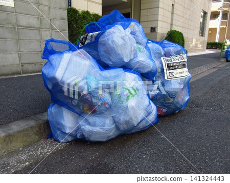 Plastic packaging waste bags piled up on the streets of Tokyo Plastic packaging waste bags piled up on the streets of Tokyo 141324443
