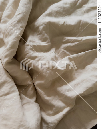 Rumpled cream duvet cover texture with soft folds, extreme close up 141325304