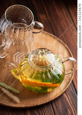 Herbal tea brewing with lemon, orange, and mint Herbal tea brewing with lemon, orange, and mint 141325679