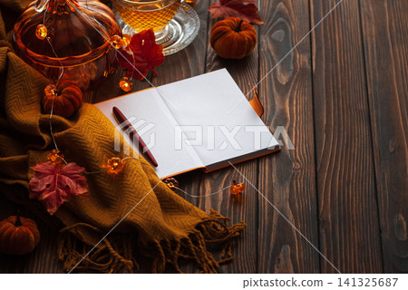 Autumn cozy tea scene with notebook and pen Autumn cozy tea scene with notebook and pen 141325687