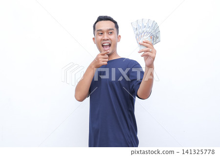 Man beams joyfully, flexing arm proudly. He holds money in one hand, smiling widely. Studio lighting highlights his enthusiastic expression. Perfect for business, finance, or success-themed projects Man beams joyfully, flexing arm proudly. He holds money in one hand, smiling widely. Studio lighting highlights his enthusiastic expression. Perfect for business, finance, or success-themed projects 141325778