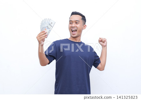 Man holds money, eyes wide, mouth open in surprise. He gestures with free hand, showing excitement. Pure white background emphasizes his reaction. Ideal for finance, unexpected gains, or lucky moments Man holds money, eyes wide, mouth open in surprise. He gestures with free hand, showing excitement. Pure white background emphasizes his reaction. Ideal for finance, unexpected gains, or lucky moments 141325823