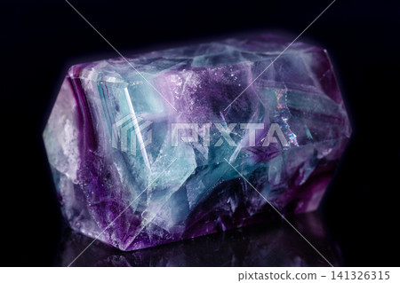 Macro mineral stone Fluorite crystal on a black background Macro mineral stone Fluorite crystal on a black background 141326315