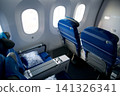 Warsaw, Poland, May 10 2018: View through premium economy cabin towards economy class on a flight to the USA 141326341