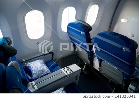 Warsaw, Poland, May 10 2018: View through premium economy cabin towards economy class on a flight to the USA Warsaw, Poland, May 10 2018: View through premium economy cabin towards economy class on a flight to the USA 141326341