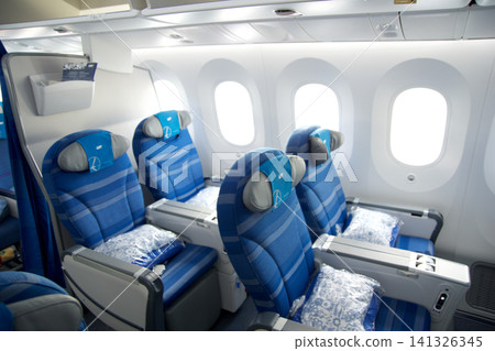Warsaw, Poland, May 10 2018: View through premium economy cabin towards economy class on a flight to the USA Warsaw, Poland, May 10 2018: View through premium economy cabin towards economy class on a flight to the USA 141326345