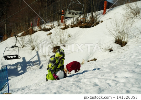 Child Playing in Snow with Dog on Sunny Winter Day Child Playing in Snow with Dog on Sunny Winter Day 141326355