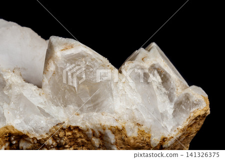 Macro mineral stone Snow quartz with calcite on a black background Macro mineral stone Snow quartz with calcite on a black background 141326375