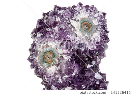 Macro mineral stone Amethyst eye, in the form of an owl on a white background Macro mineral stone Amethyst eye, in the form of an owl on a white background 141326415