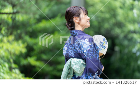 Japanese summer - Japanese woman in a yukata holding a fan Japanese summer - Japanese woman in a yukata holding a fan 141326517