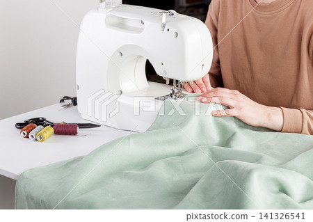 Sewing machine, stitching fabrics, needle in a round plan Sewing machine, stitching fabrics, needle in a round plan 141326541