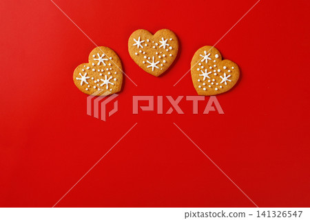 beautiful hand-baked cookies in the shape of a heart on a red background beautiful hand-baked cookies in the shape of a heart on a red background 141326547
