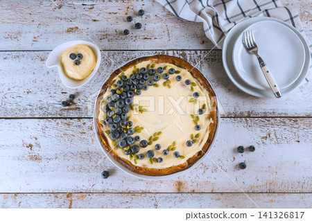 Blueberry dessert with cream on wooden table at kitchen setting Blueberry dessert with cream on wooden table at kitchen setting 141326817