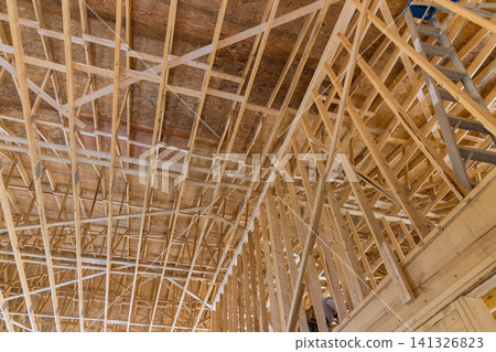 Construction of wooden framework inside large building in work site Construction of wooden framework inside large building in work site 141326823