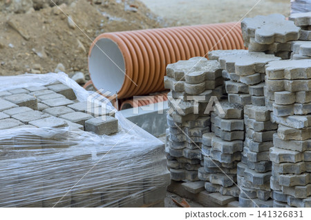 Construction materials are stacked on site with pipes bricks in view Construction materials are stacked on site with pipes bricks in view 141326831
