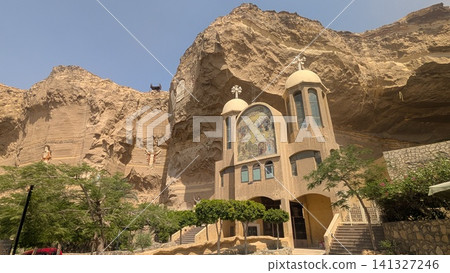 The majestic view of the entrance of one of the cave churches in front of the rocky cliff 141327246