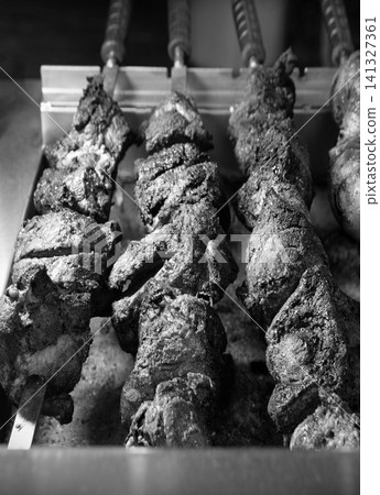 A ruddy kebab is being grilled on a barbecue A ruddy kebab is being grilled on a barbecue 141327361
