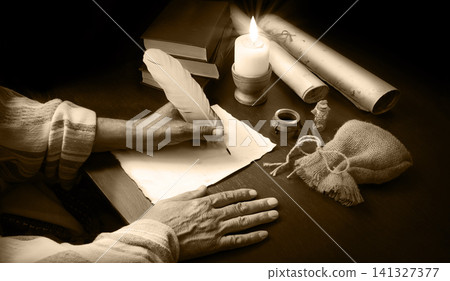 Man writing a letter on a desk Man writing a letter on a desk 141327377