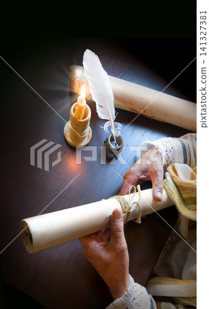 Man holding an old scroll Man holding an old scroll 141327381