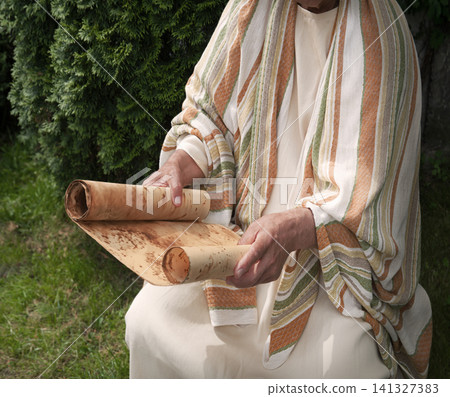Old man reading the scroll Old man reading the scroll 141327383