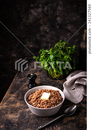 Buckwheat porridge with butter in a white bowl Buckwheat porridge with butter in a white bowl 141327560