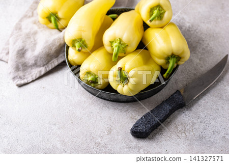 Raw uncooked yellow bell pepper Raw uncooked yellow bell pepper 141327571