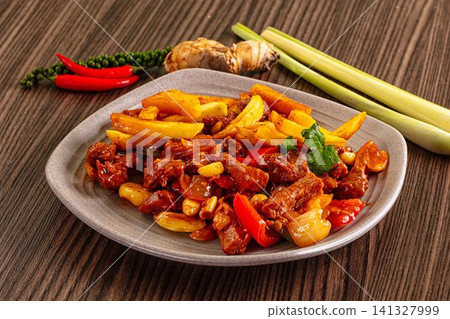 Spicy beef stir fry with pineapple and peppers on ceramic plate Spicy beef stir fry with pineapple and peppers on ceramic plate 141327999