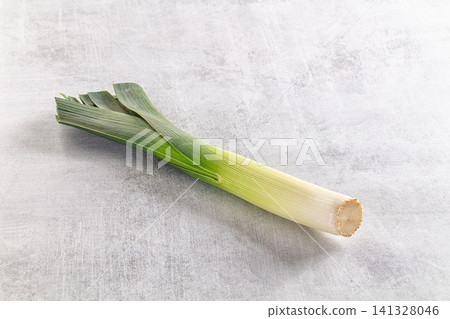 Fresh leek on textured gray surface Fresh leek on textured gray surface 141328046