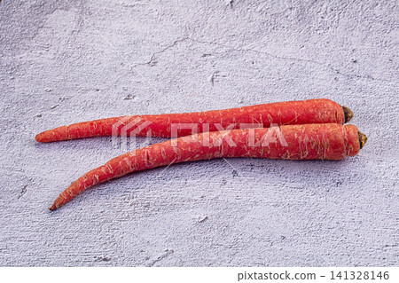 Two fresh carrots on textured gray surface Two fresh carrots on textured gray surface 141328146