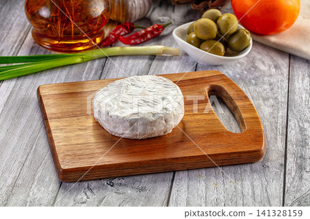Round Camembert Cheese on Wooden Board with Olives and Spices Round Camembert Cheese on Wooden Board with Olives and Spices 141328159