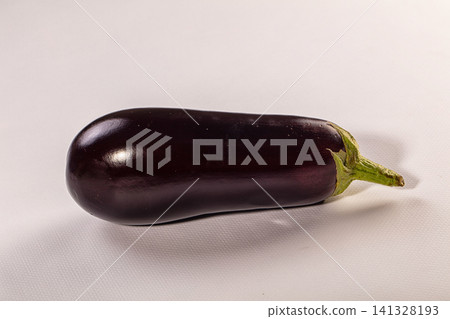 Fresh eggplant with glossy purple skin and green stem on white background Fresh eggplant with glossy purple skin and green stem on white background 141328193