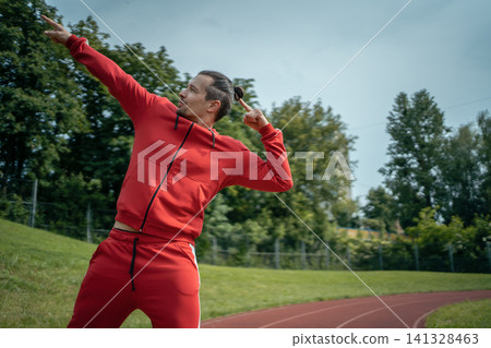 young cheerful personal fitness trainer at running track young cheerful personal fitness trainer at running track 141328463