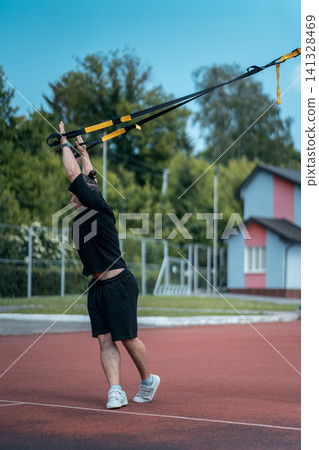 young sporty athlete or bodybuilder has fitness workout outdoor 141328469