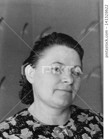 Vintage Soviet Woman in a Floral Dress with Neatly Styled Hair Vintage Soviet Woman in a Floral Dress with Neatly Styled Hair 141328622