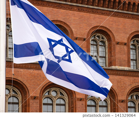 Flags of Israeli waving in front of a Rotes Rathaus building of Berlin city hall, symbolizing global political discussions, cultural connections, and international diplomacy. Flags of Israeli waving in front of a Rotes Rathaus building of Berlin city hall, symbolizing global political discussions, cultural connections, and international diplomacy. 141329064