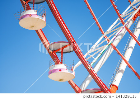 Close up Ferris Wheel Against Blue Sky 141329113