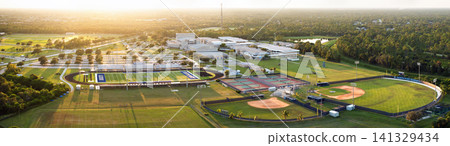 Aerial view of high school open air sports facilities in Florida. American football stadium, tennis court and baseball diamond sport infrastructure. Aerial view of high school open air sports facilities in Florida. American football stadium, tennis court and baseball diamond sport infrastructure. 141329434
