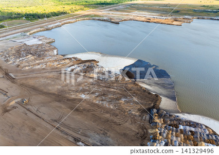 Active phosphate mine in Florida with slurry pipeline transporting water, clay and sand from dredging pit. Active phosphate mine in Florida with slurry pipeline transporting water, clay and sand from dredging pit. 141329496