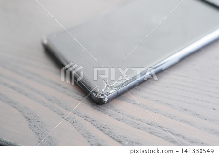 Close-up of a smartphone with a cracked screen Close-up of a smartphone with a cracked screen 141330549