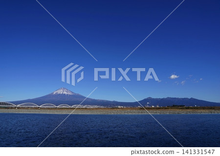Mount Fuji, Mount Ashitaka, and the Fujikawa River stand out against the blue sky. January. Mount Fuji 2098. Mount Ashitaka and the Fujikawa Aqueduct Bridge. Mount Fuji, Mount Ashitaka, and the Fujikawa River stand out against the blue sky. January. Mount Fuji 2098. Mount Ashitaka and the Fujikawa Aqueduct Bridge. 141331547