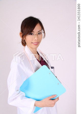 A woman in a white coat A woman in a white coat 141331800